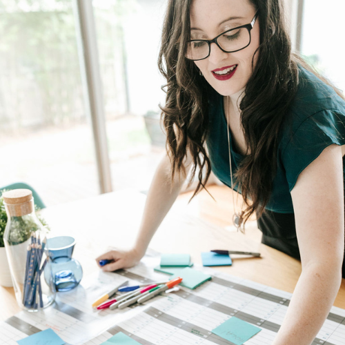 Leanne Woff leaning over a table with a calendar